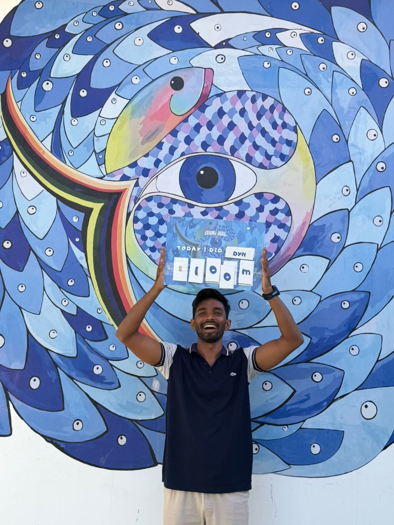 Waqar Khan with a board reading 110 metres dynamic